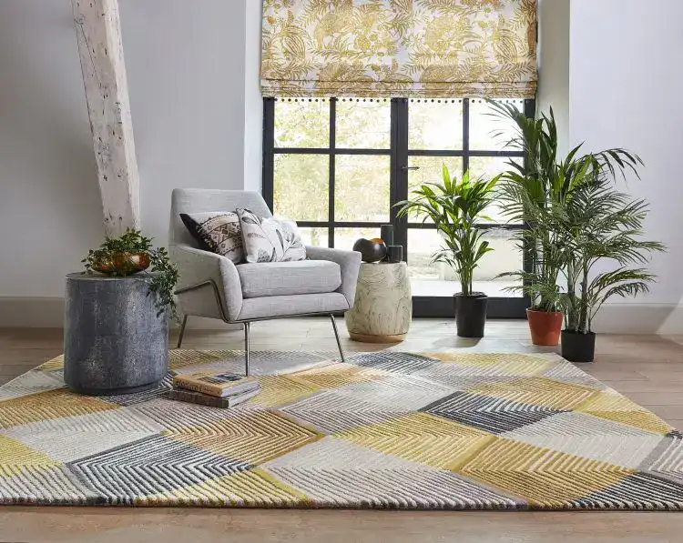 Modern living room with Rhythm Rug Saffron, grey armchair, and indoor plants.