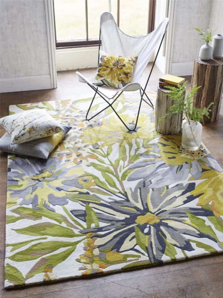 Vibrant floral patterned rug in yellow, green, and blue tones for living room decor.