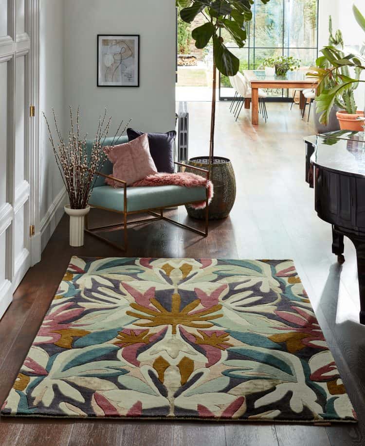 Bright living room with colourful floral rug, plants, and modern decor.
