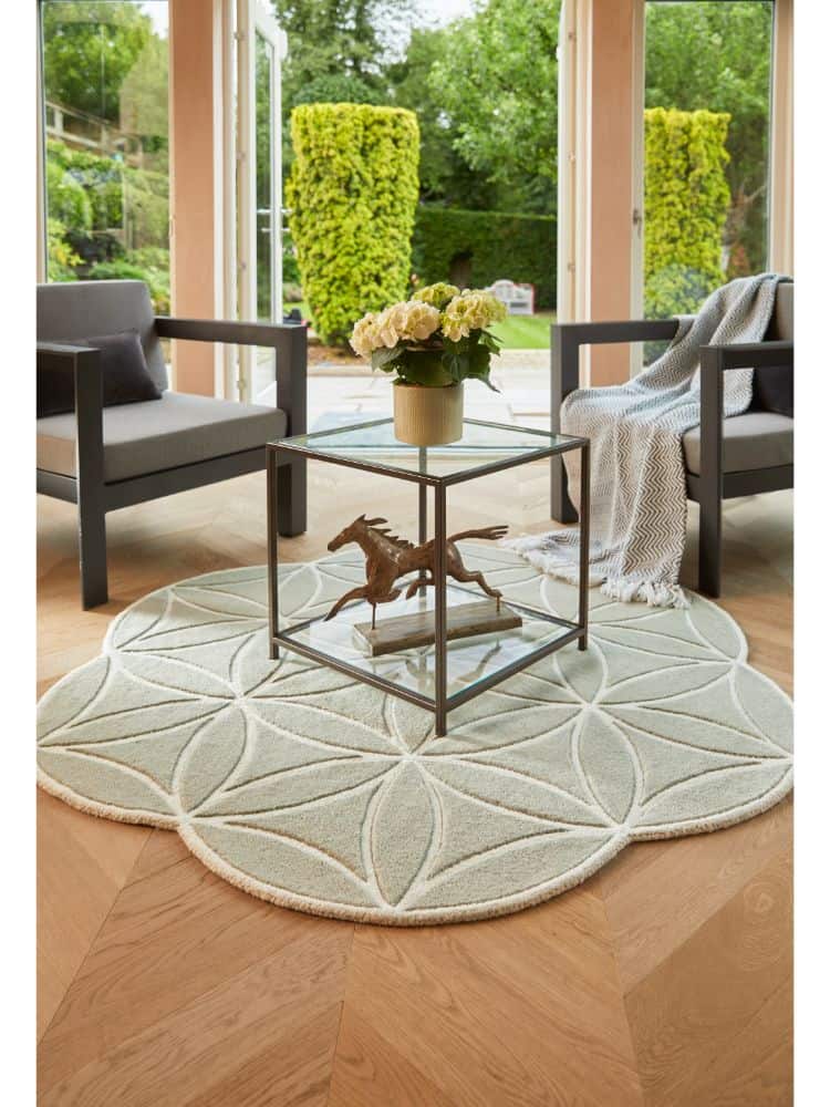 Elegant soft green Bloom rug in a bright living room setting.