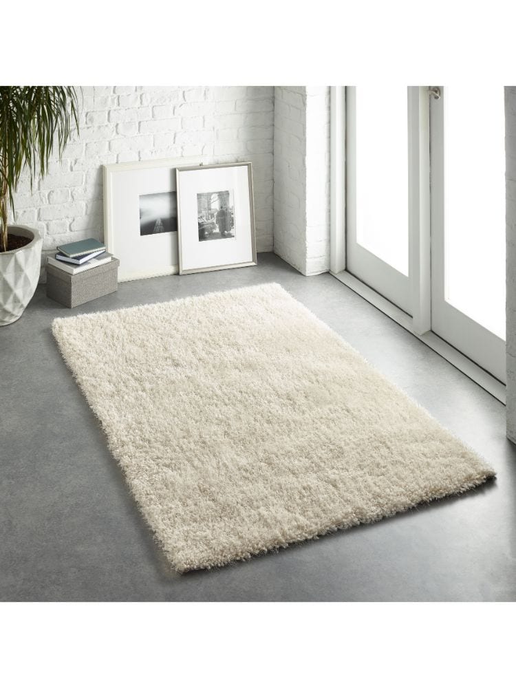 Cream shaggy rug in modern minimalist room near glass door.