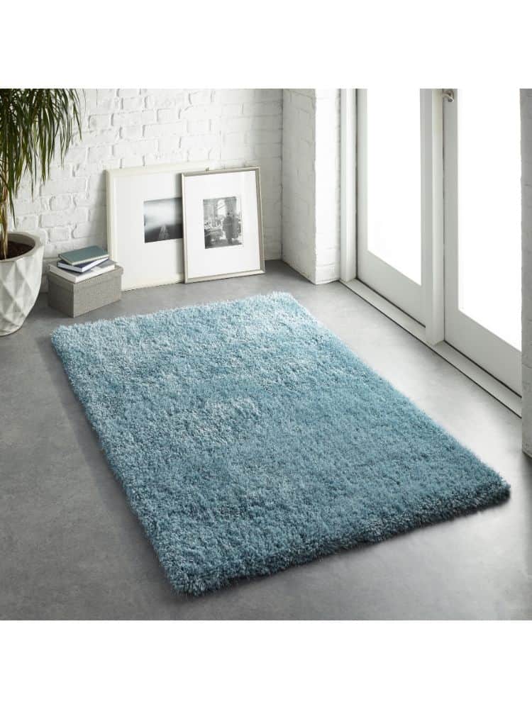 Duck Egg Rug in Modern Interior with White Brick Wall and Natural Light.