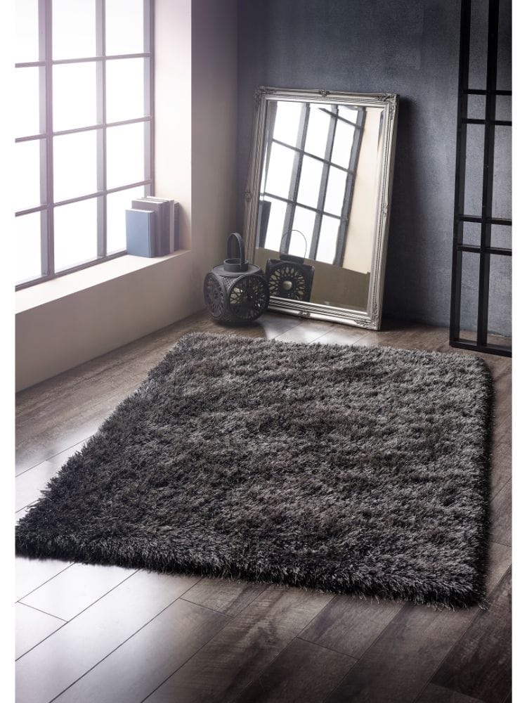 Charcoal shaggy rug in modern room with mirror and decor.