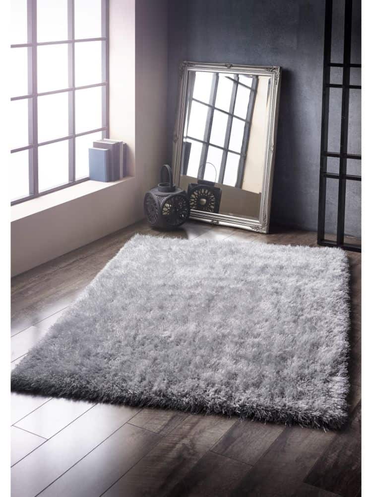 Luxurious silver shaggy rug in modern living room setting.