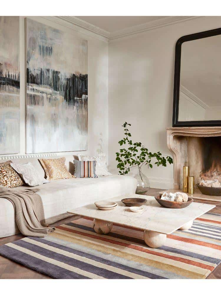 Elegant living room with Rosita Rug Harissa, modern decor, and abstract art.