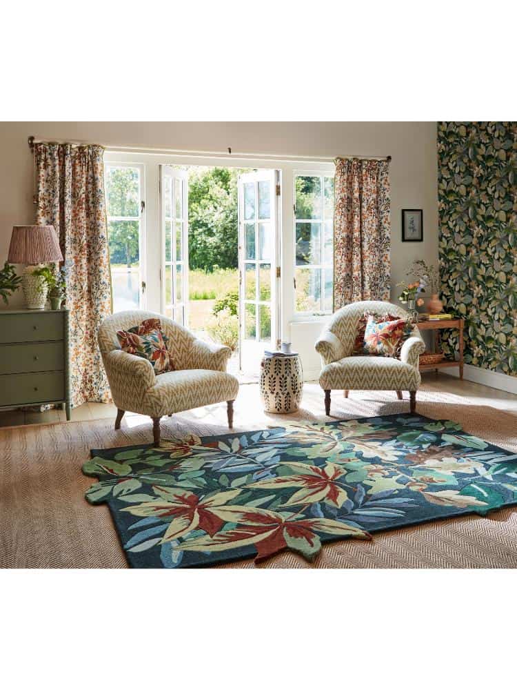 Forest green rug with floral pattern in bright living room.