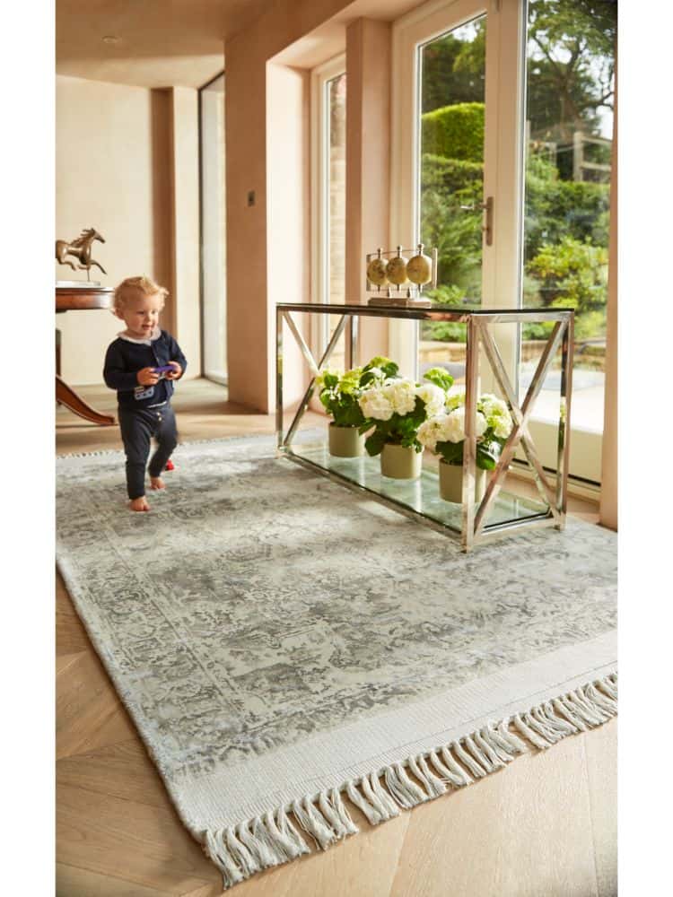 Vintage fringe rug in mocha with floral decor in a bright living room.