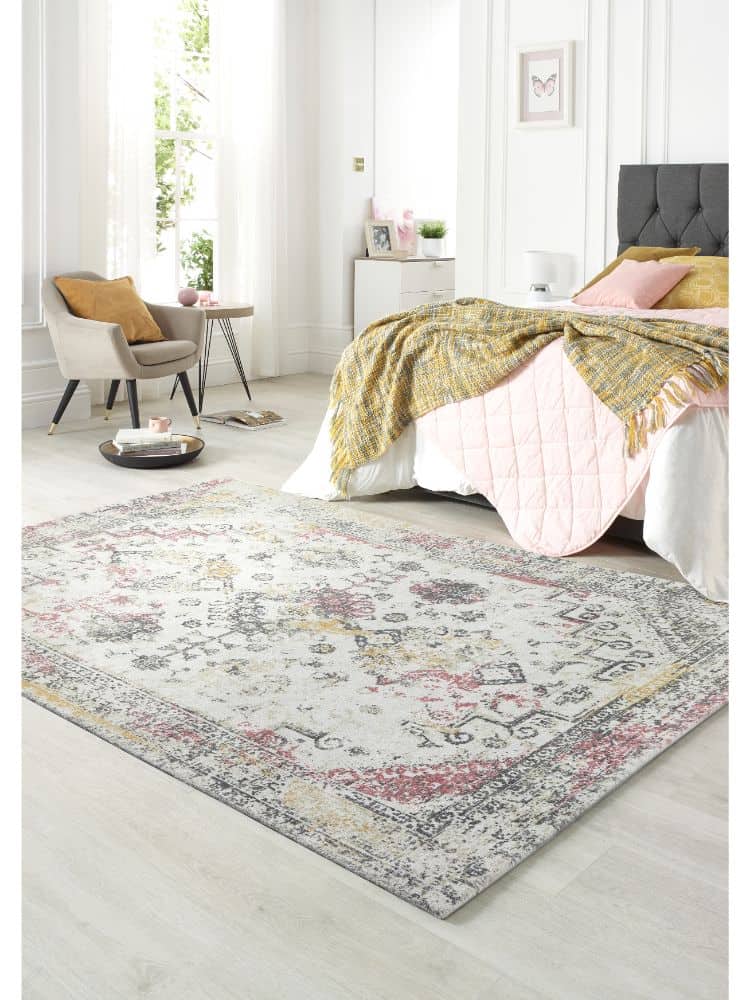 Vogue Rug Pink/Ochre in a bright, modern bedroom setting with natural light.