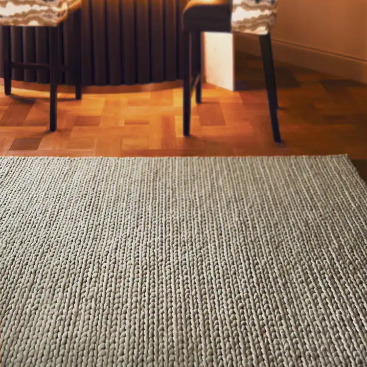 Close-up of Fusion Rug Oyster with textured pattern on wooden floor.