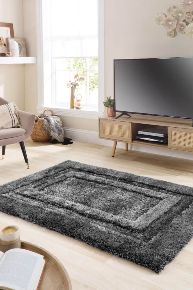 Charcoal textured shaggy rug in modern living room setting.