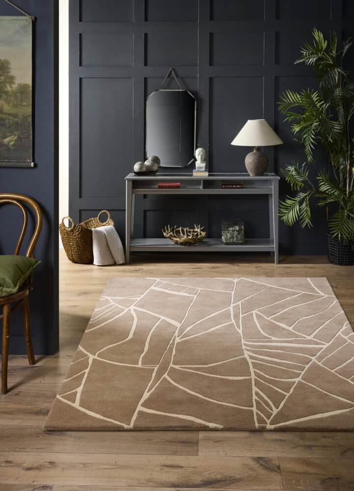 Modern beige rug with abstract leaf pattern in stylish living room.