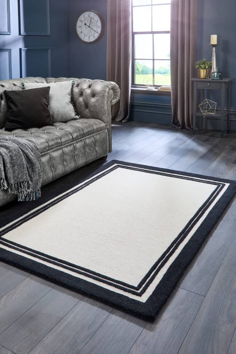 Taupe and black Piper Rug in modern living room with grey sofa.