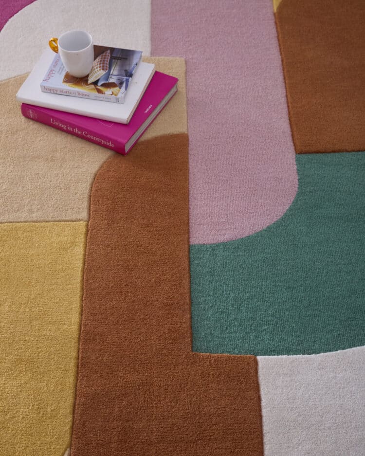 Colourful retro deco rug in pink, green, beige, and brown shades for stylish living spaces.
