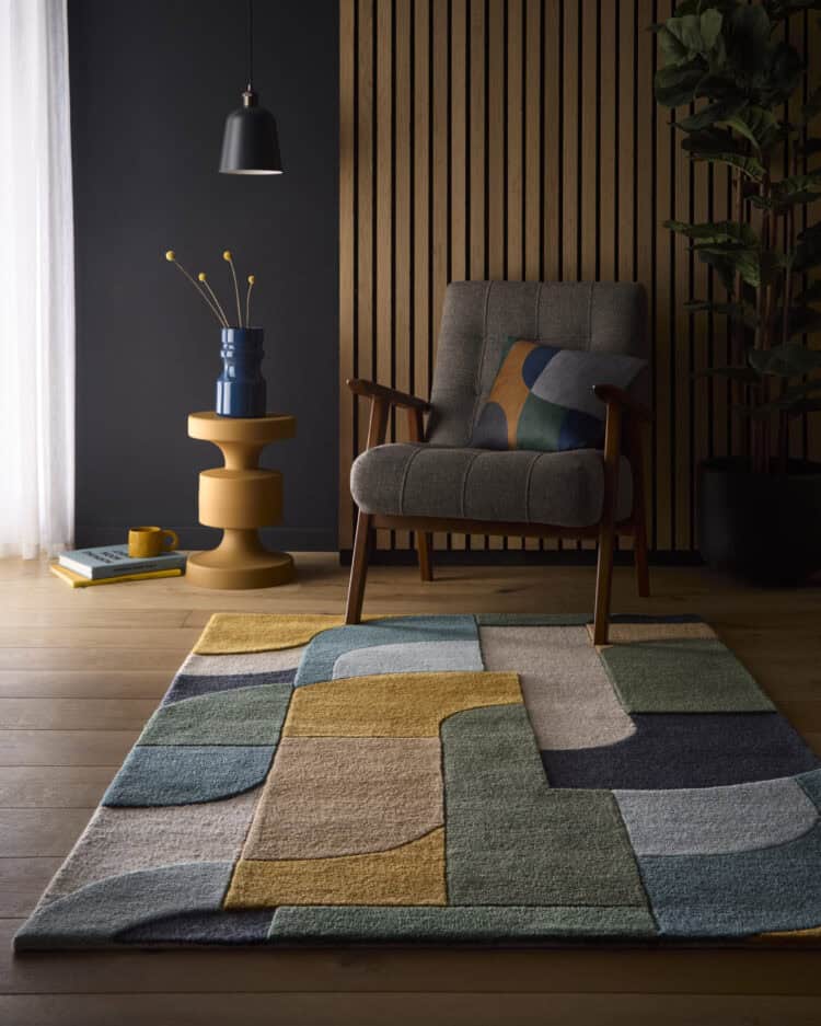 Colourful retro deco rug in blue, yellow, and grey tones in a contemporary living room.