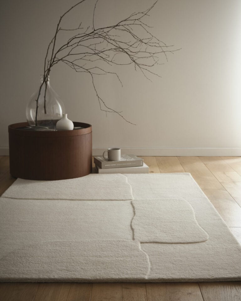 Elegant wool rug in stone oatmeal with a modern minimalist decor.