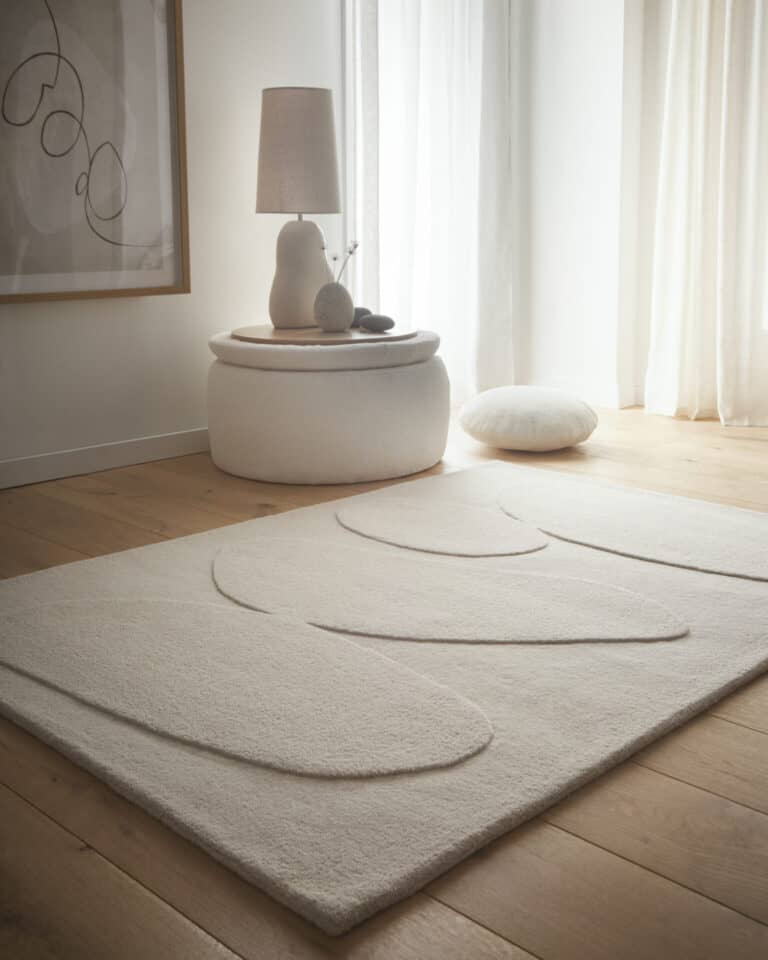 Elegant wool rug in stone oatmeal colour in a modern living room setting.