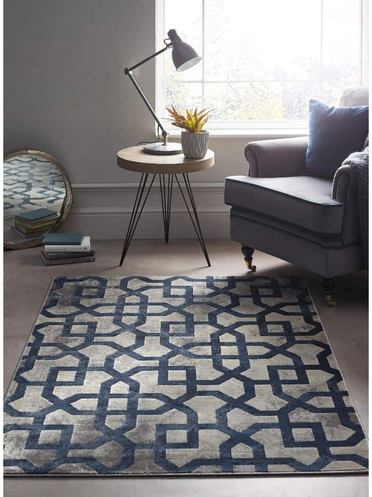 Blue and grey geometric rug in a contemporary living room setting.